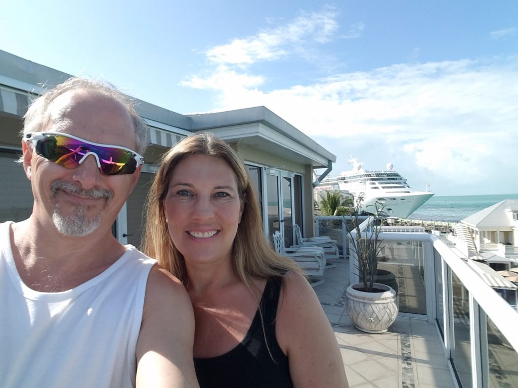 photo of cindi and jeff in florida by the ocean with a cruise ship in the background