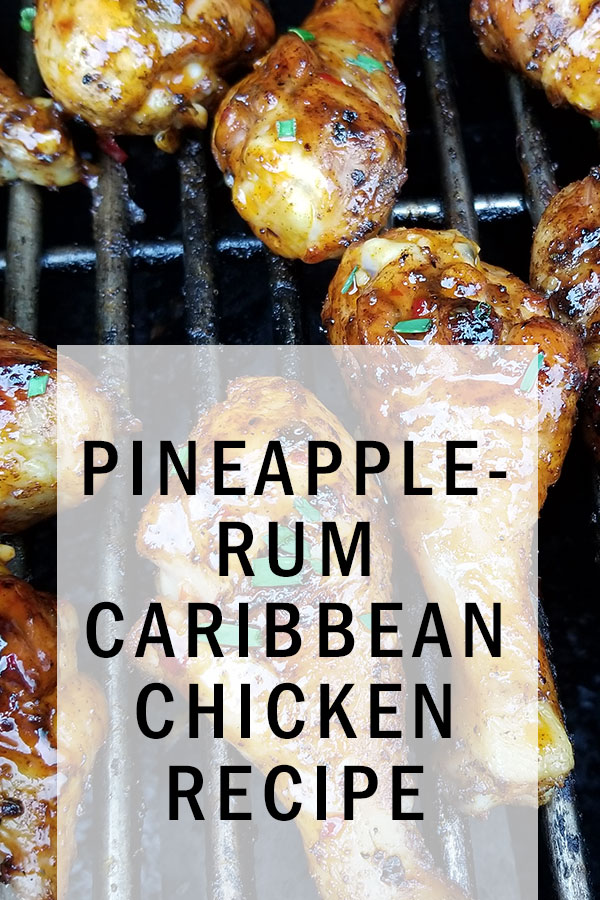 Glazed drumsticks on a grill. Golden cross marks from the grill with green onion on each leg. White transparent box on top of photo saying Pineapple-Rum Caribbean Chicken Recipe