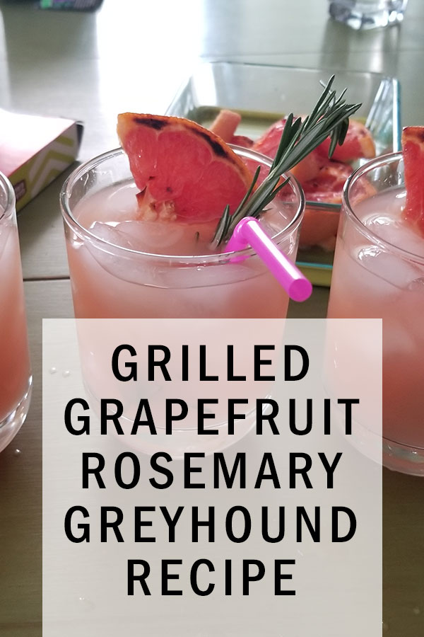 Three rock glasses filled with ice and pink grapefruit juice. Garnished with a pink straw, a piece of grilled grapefruit and a sprig of rosemary. A white transparent box with the title Grilled Grapefruit Rosemary Greyhound Recipe