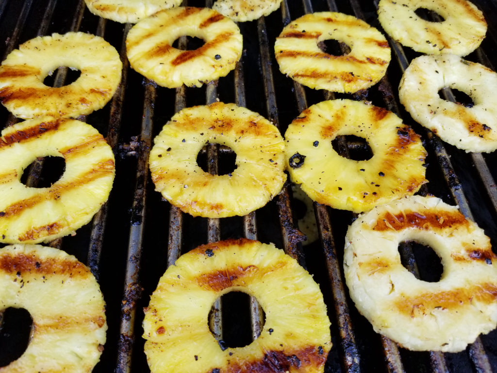 Pineapple rings on a grill with golden grill marks