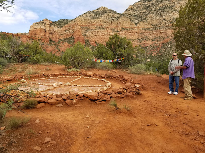A photo of Sedona's energy vortex and medicine wheel with a shaman guide and student talking