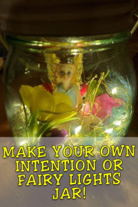 A fairy in a lighted glass jar with flowers, with the words, Make Your Own Intention or Fairy Lights Jar