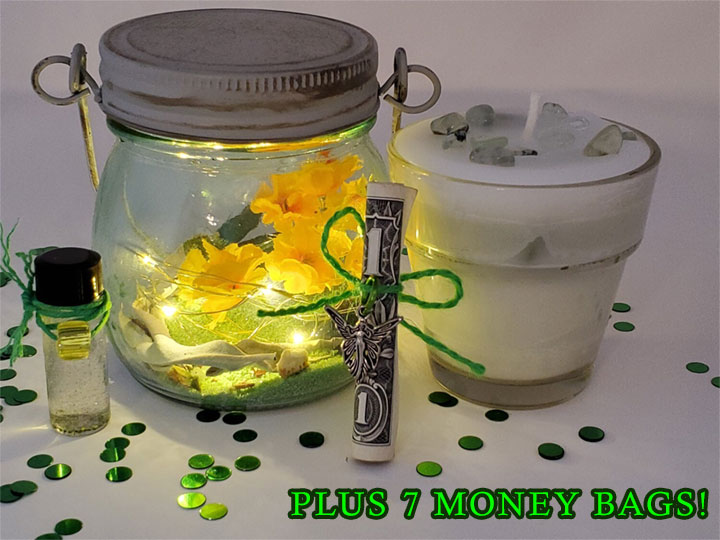 A lighted jar filled with flowers, a vial of money drawing oil, a rolled dollar bill tied with with green jute and a fairy charm, a hand poured candle with Prehnite gem crystals and the words, Plus 7 Money Bags